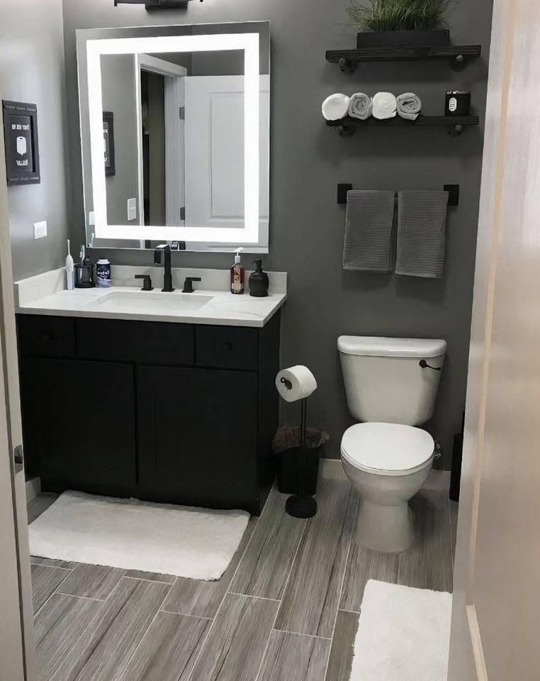 Modern bathroom with black vanity and LED mirror