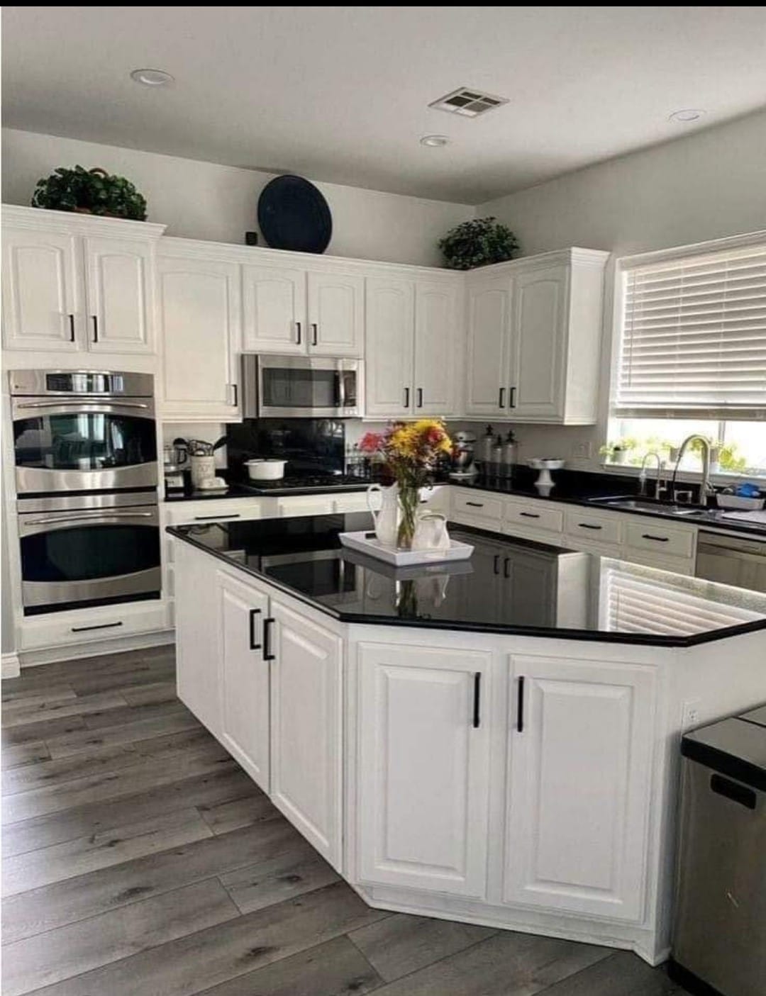 Bright, modern kitchen with white cabinetry, black accents